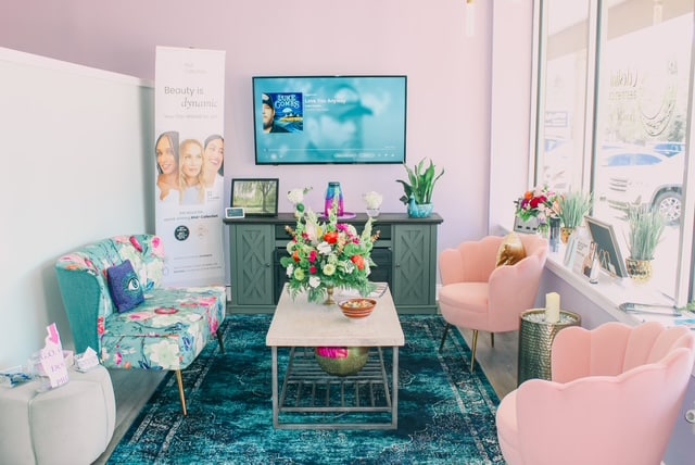 a living room filled with furniture and pictures on the wall